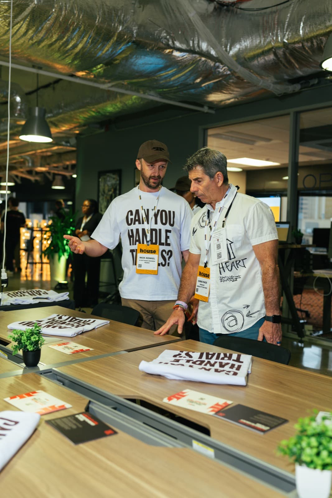 Team members at the merch table